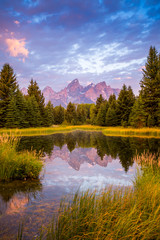 The morning sky erupts in color above the Teton Mountain Range in Grand Teton National Park.