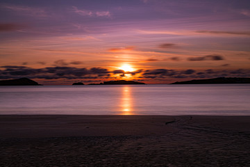 Fototapeta premium Pink glow sunset with silhouette clouds on the wild atlantic way at Bunbeg, Donegal, Ireland