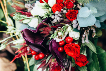 Wedding rings lie in the bride's wedding bouquet