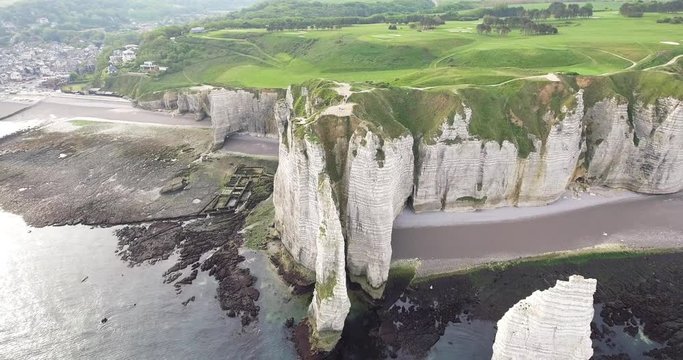 Chalk cliffs of Etretat (Normandy France) with the natural arch Porte d'Aval and the stone needle called L'Aiguille - Image. Top view, 4K25ftp