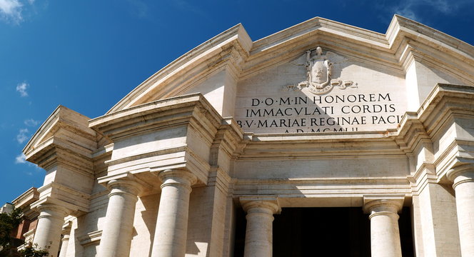 Rome, Italy - September 08, 2019: Main facade of the Basilica of the Sacred Heart Immaculate of Mary, in Piazza Euclide in Rome. with a Greek cross plan inscribed in a circle and an elaborate facade
