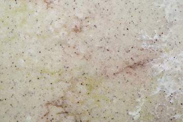 Texture light brown artificial stone with black crumbs.