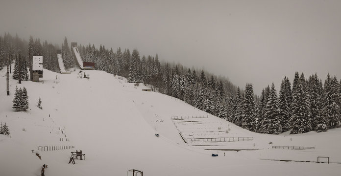 Panoramic view of abandoned ski jumps on the mountain of Igman in Ilidza, a venue of olympic games in 1984. Hazy and foggy panorama of old ski jumps.