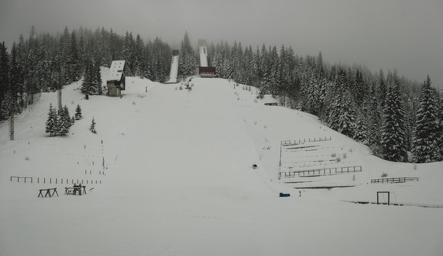 Panoramic view of abandoned ski jumps on the mountain of Igman in Ilidza, a venue of olympic games in 1984. Hazy and foggy panorama of old ski jumps.