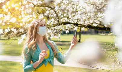 Woman enjoying the spring blossom despite the Coronavirus crisis