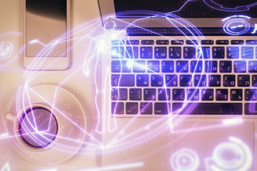 Education hologram drawings over computer on the desktop background. Top view. Multi exposure.
