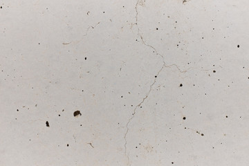 Chapped concrete wall with small holes for artistic backgrounds