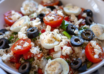 Helathy quinoa with some vegetables dices like pepper, onion, bright cherry tomatoes and eggs. Protein Dish. Healthy diet salad. Close up