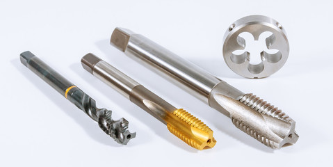 Tap for threading in metal on white background. Tool for metal processing.