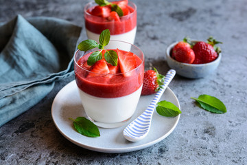 Panna cotta with strawberry sauce topping, served in a glass jar