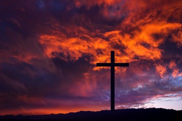 Wooden cross against sky background   , Easter background. Christian cross against celestial clouds. 