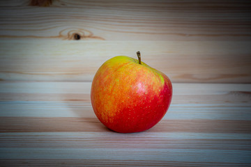 Red fresh apple on wood table