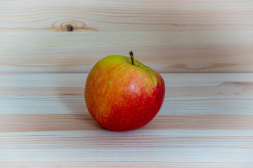 Red fresh apple on wood table