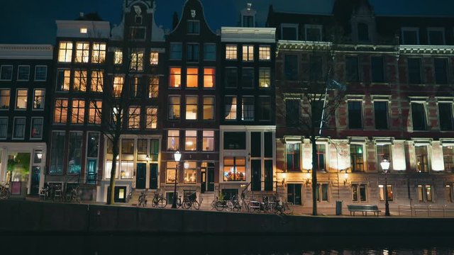 Traditional old dancing houses or buildings in Amsterdam at night, the Netherlands