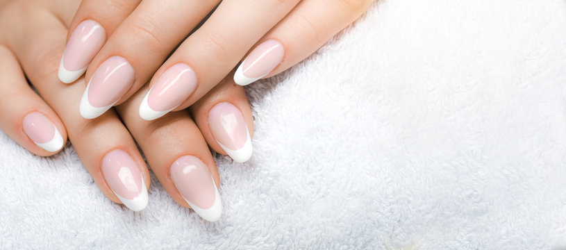Manicure and Hands Spa. Beautiful Woman hands closeup. Manicured nails and Soft hand skin wide banner.
