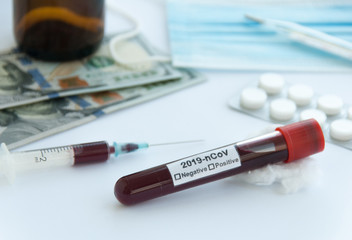 Coronavirus blood test. Sample test, pills, medical mask, dollar banknotes, thermometer and syringe on white background