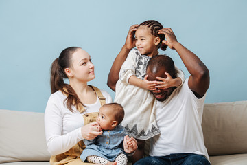 Family posing for a photo, daughter misbehaves, having fun.