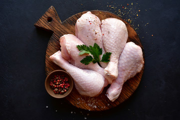 Raw chicken legs with spices. Top view with copy space. © lilechka75