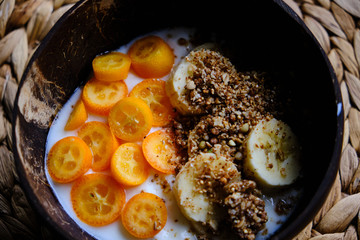 Healthy snack, yoghurt with kumquat, granola, banana