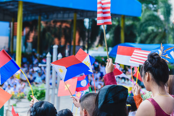 Celebrate ASEAN Day falls on Aug. 8,Students hand holding carry the flag of of the Association of Southeast Asian Nations,Celebrating 47 years of ASEAN