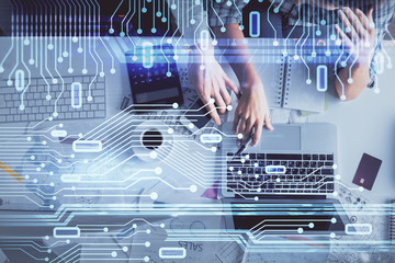 Double exposure of man and woman working together and data theme hologram drawing. Computer background. Top View.