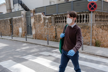 White male walking on the street of a residential area with gloves and mask for shooping