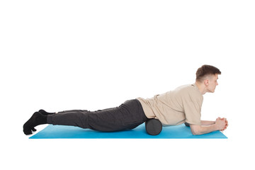 Handsome man shows exercises using a foam roller