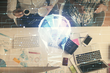 Double exposure of man and woman working together and bulb drawing. Computer background. Top View. Idea concept.