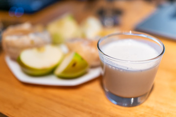 Sour foods sliced fruit vegetables serving setting on wooden table kombucha juice shot glass and foam closeup for miracle berry tasting