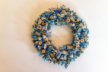 Bright retro vintage antique room wreath blue dry flower decorations in home house hanging on wall...