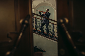 young caucasian musician violinist perform music in the hall before concert, practice playing violin. classical instruments, music concept