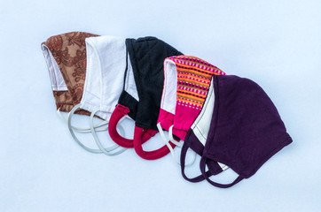 All five pieces of cloth masks have different colorful patterns.