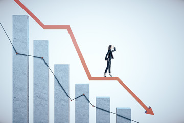 Businesswoman standing on business chart with downtrend graph.