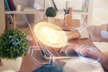 Double exposure of woman hands typing on computer and crypto market theme hologram drawing. Blockchain concept.