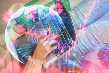 Double exposure of woman hands typing on computer and business theme hologram drawing. Success...