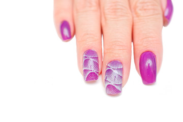 female fingers with painted nails. lilac nails with a pattern.