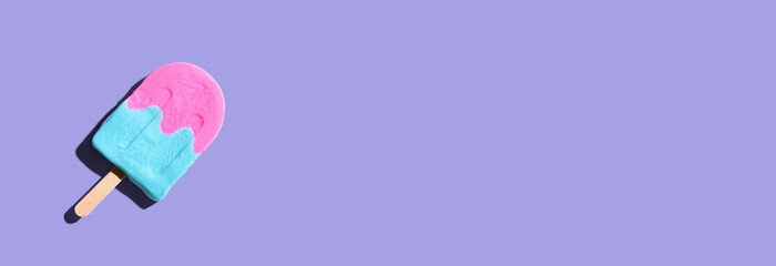 Pink and blue popsicle with shadow - overhead view
