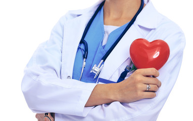 Positive female doctor standing with stethoscope and red heart symbol isolated