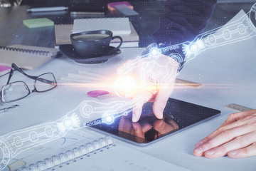 Double exposure of man's hand holding and using a digital device and data theme drawing. Technology concept.