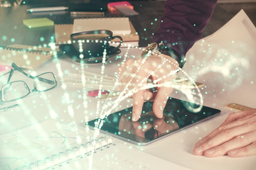 Double exposure of man's hands holding and using a phone and DNA drawing. Medical education concept.