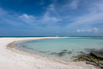 Tropical white beach with crystalline water in a little sandbank called 