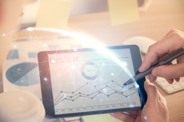 Double exposure of man's hands holding and using a phone and social network theme drawing.