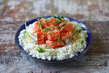 Selective focus. Macro. Poke bowl with salmon and microgreens. Healthly food.