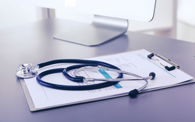 Medical equipment: blue stethoscope and tablet on white background. Medical equipment