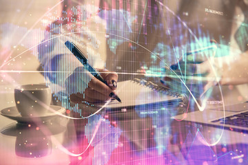 Double exposure of business theme sketch hologram and woman holding and using a mobile device.