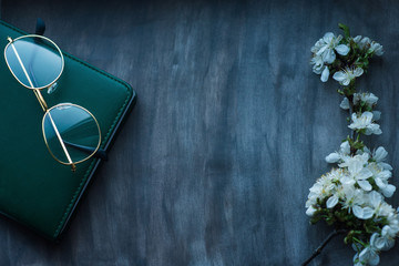 Fototapeta premium A composition of notebook and glasses on a vintage background