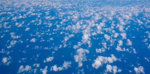 Fototapeta na wymiar small cirrus clouds high in the blue sky