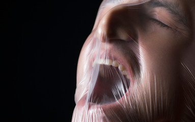 close-up portrait of a plastic bag on the face asphyxiation