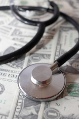 view of stethoscope on dollar banknotes, health insurance concept