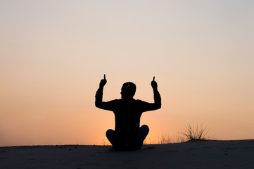 silhouette photo man sitting on sky background